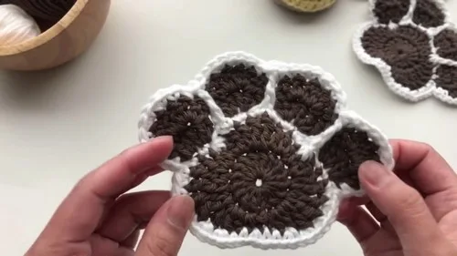 Crochet paw print coaster with shaped toe pads