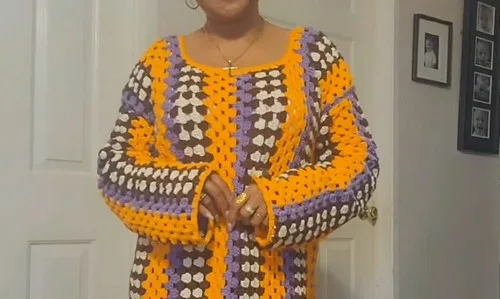 A flowing crochet dress in cream, brown, orange and purple